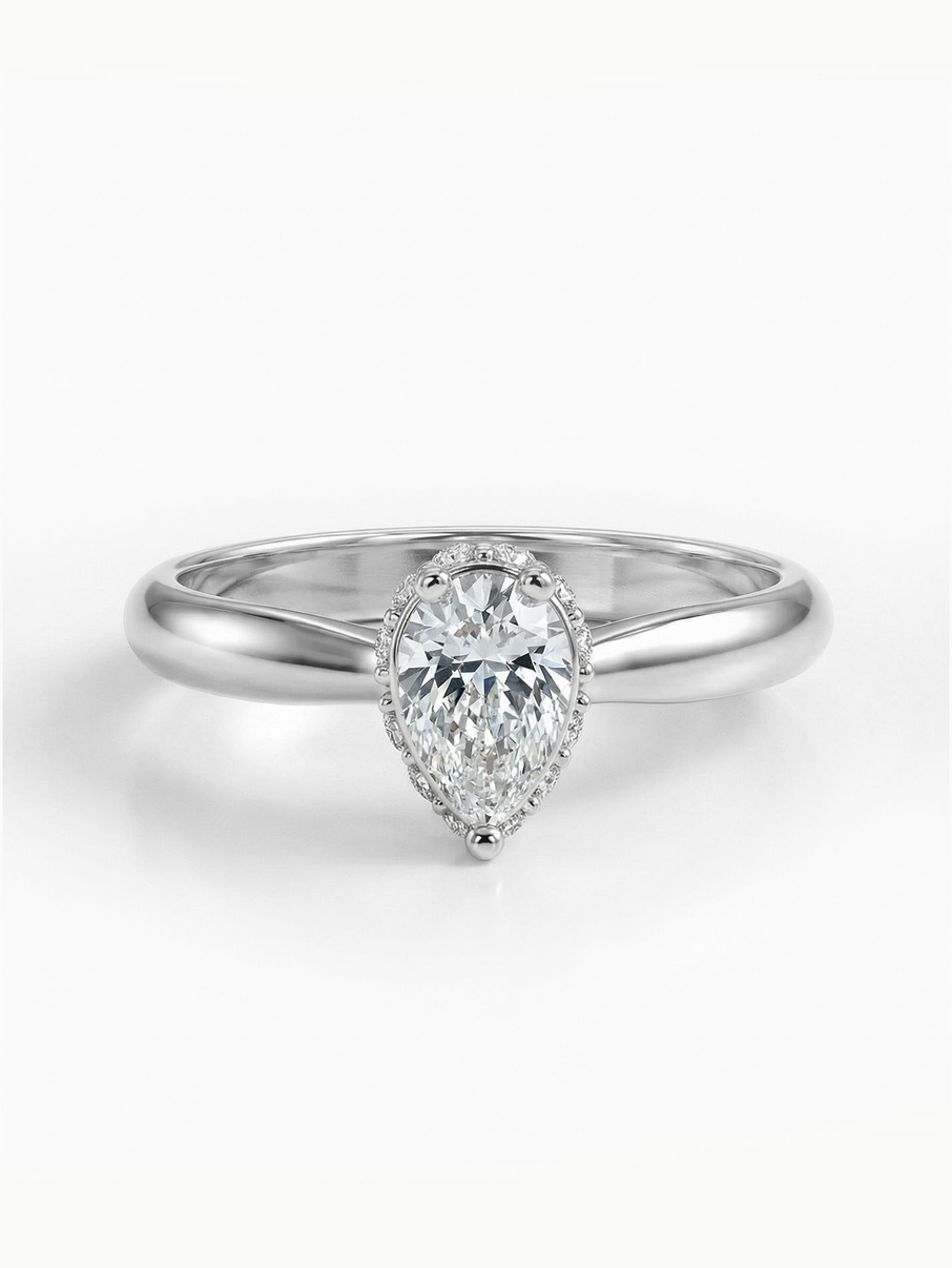 White gold engagement ring with a minimalist design and a radiant pear-cut diamond