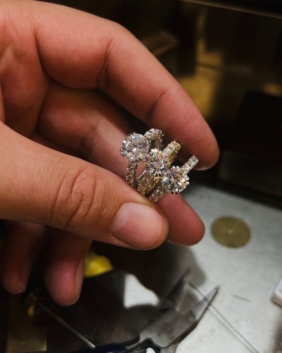 3 prsteny z bílého a žlutého zlata osázeny diamanty a centrálním briliantem
