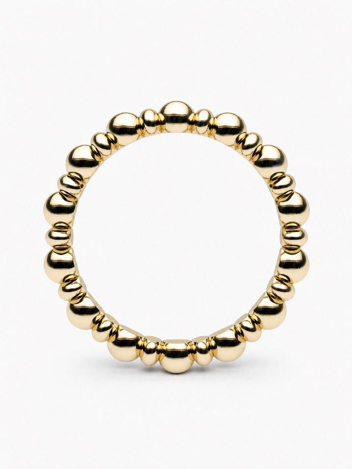 A minimalist gold ring featuring delicate beads and ovals