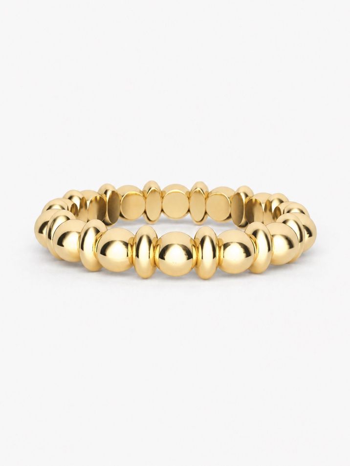 A minimalist gold ring featuring delicate beads and ovals