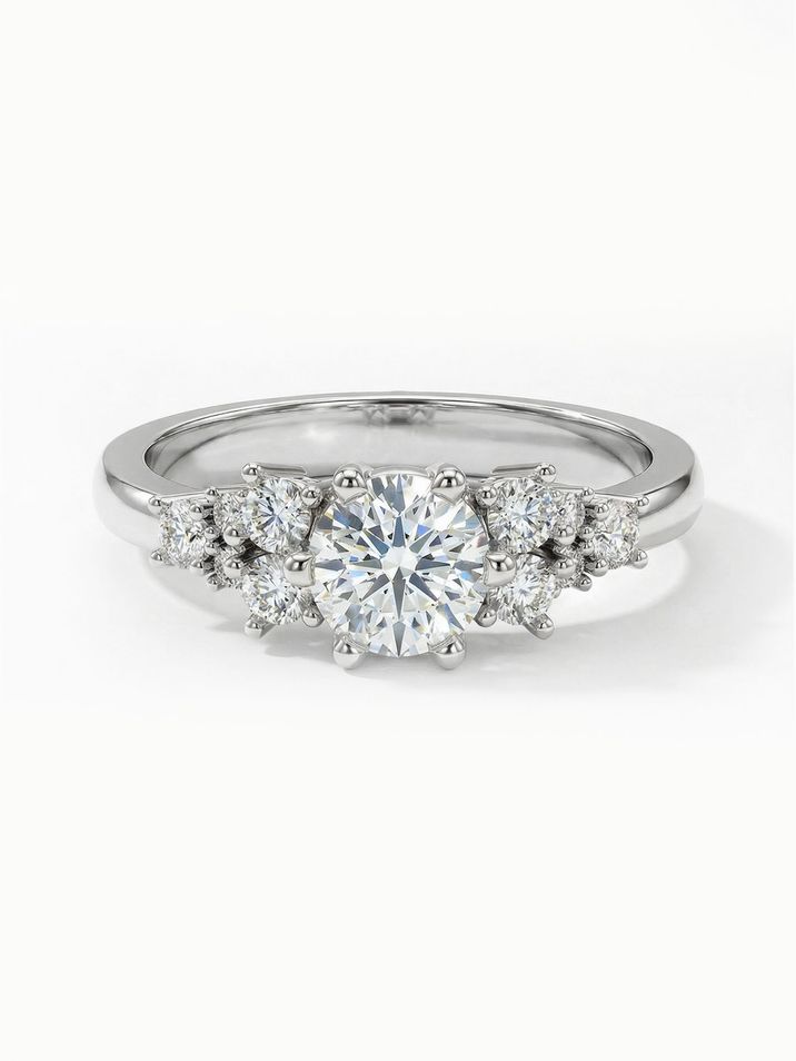White gold engagement ring with a 4.5 mm centre stone surrounded by several smaller stones