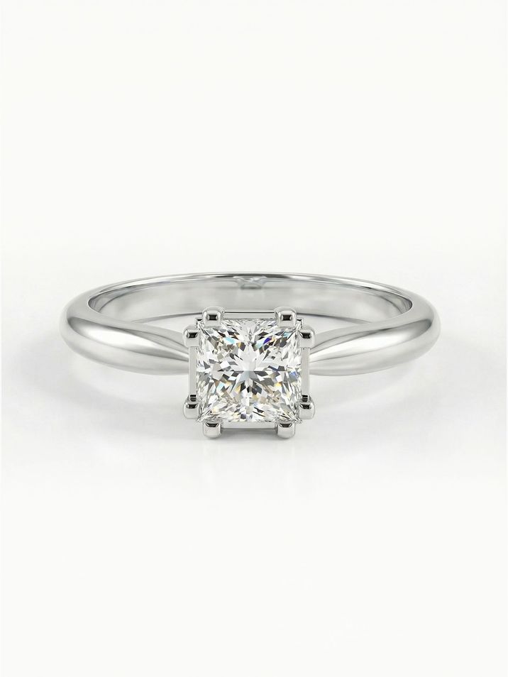 Elegant white gold engagement ring with a square princess-cut stone and a smooth band